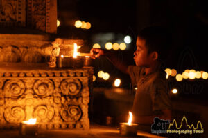 kid lighting up candles at meak bochea