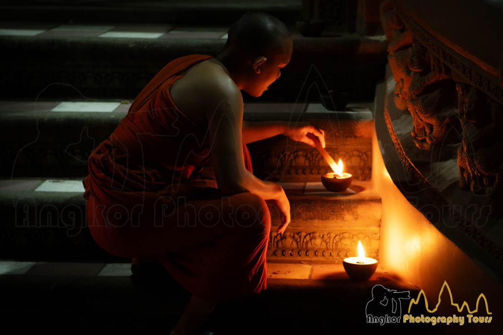 monk lighting up candles meak bochea